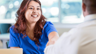 Woman shaking hand during job interview