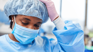 Operating Room Nurse Looking Down and Feeling Overwhelmed