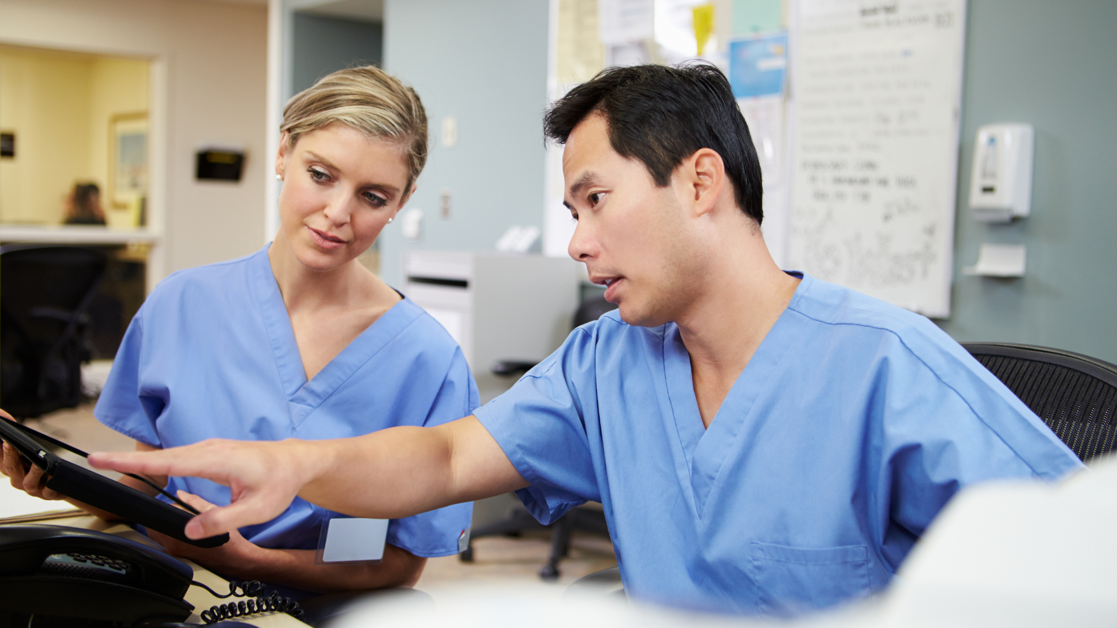 Male nurse and female nurse sitting down